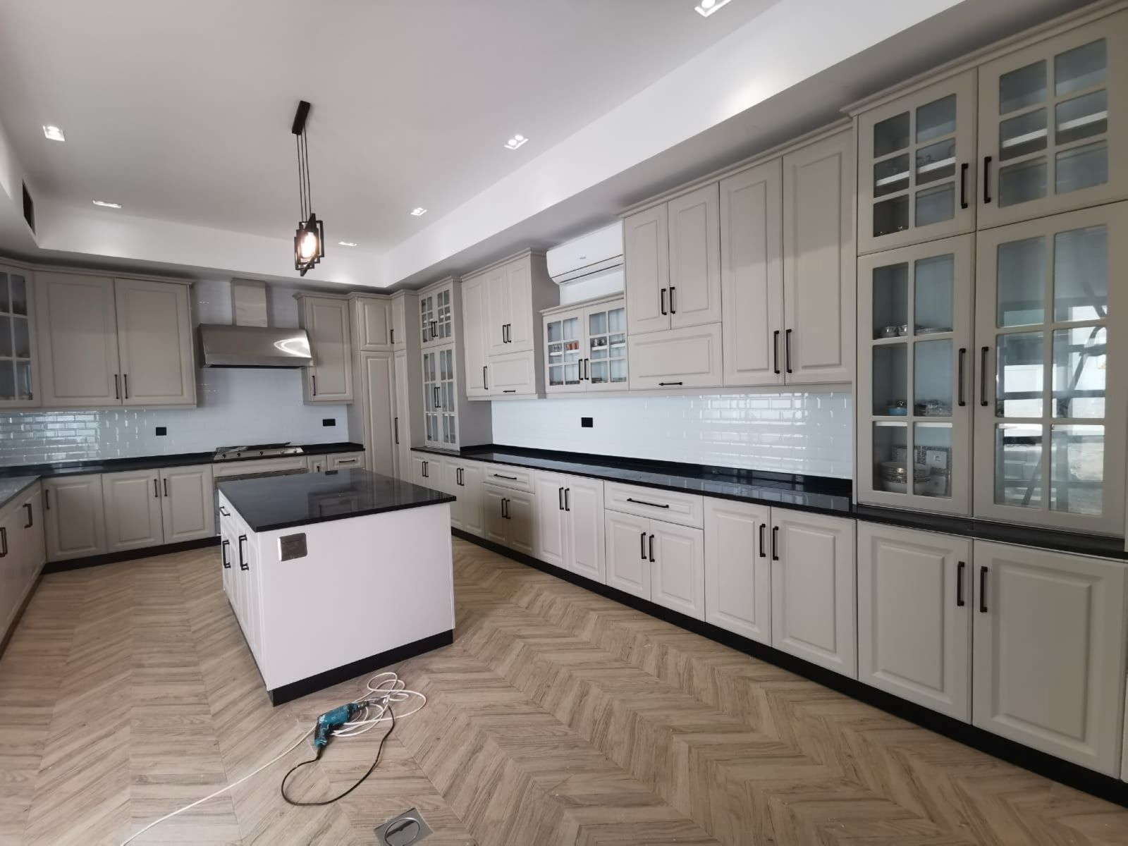 Full kitchen view with island and pendant lighting — villa project